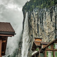 Buy canvas prints of Lauterbrunnen town with waterfall backdrop by Robert Murray