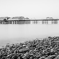 Buy canvas prints of Cromer pier seen over the pebble beach in monochro by Jason Wells