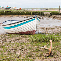 Buy canvas prints of Boat anchored to the shore at Brancaster Staithe by Jason Wells