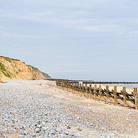 Buy canvas prints of Pebbles and sea defences at West Runton beach by Jason Wells