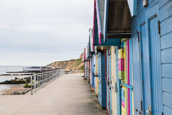 Beach huts on the promenade at Sheringham Picture Board by Jason Wells