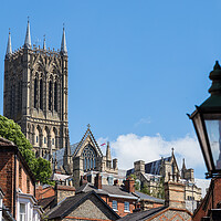 Buy canvas prints of Lincoln cathedral peaking above the rooftops of the city by Jason Wells