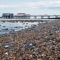 Buy canvas prints of Cromer Pier seen over the shingle beach by Jason Wells