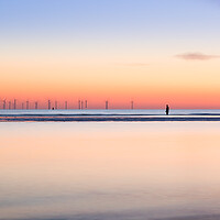 Buy canvas prints of Square crop of an Iron Man watching the spinning turbines on Bur by Jason Wells
