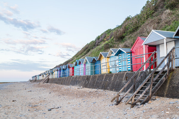 Beach huts line the promenade at Cromer Picture Board by Jason Wells