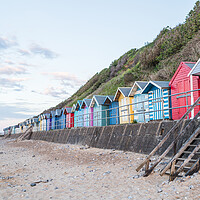 Buy canvas prints of Beach huts line the promenade at Cromer by Jason Wells