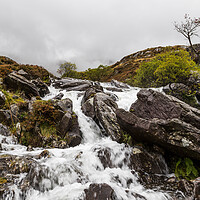 Buy canvas prints of Water crashes over rocks at Ogwen Valley by Jason Wells