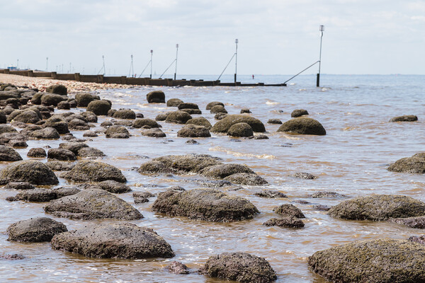 Waves lap up against the rock pools at Hunstanton beach Picture Board by Jason Wells