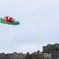 Buy canvas prints of Welsh flag above Beaumaris Castle by Jason Wells