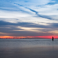 Buy canvas prints of Iron Man in front of a colourful sky by Jason Wells