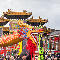 Buy canvas prints of Dragon Dance passes the paifang by Jason Wells