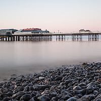 Buy canvas prints of Cromer pier seen over the pebble beach by Jason Wells