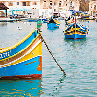 Buy canvas prints of Luzzu boats in Marsaxlokk harbour by Jason Wells
