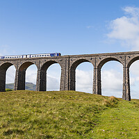 Buy canvas prints of Train passing over the Ribblehead Viaduct  by Jason Wells