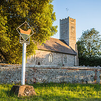 Buy canvas prints of Dunwich village sign in front of the church by Jason Wells