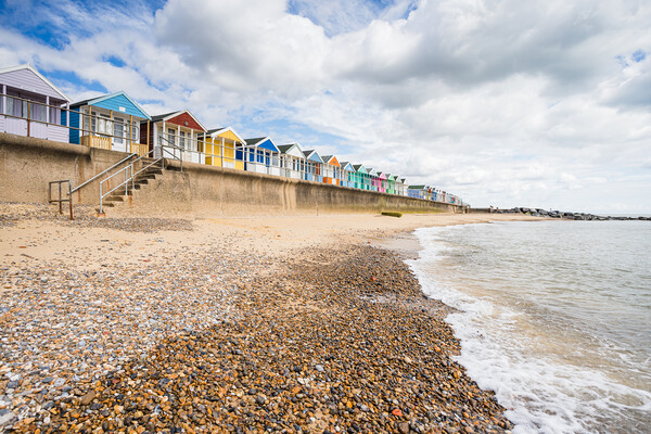 Southwold beach huts next to the pier Picture Board by Jason Wells