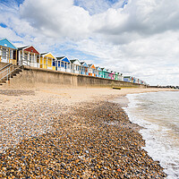 Buy canvas prints of Southwold beach huts next to the pier by Jason Wells
