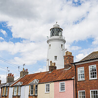 Buy canvas prints of Southwold Lighthouse behind colourful houses by Jason Wells