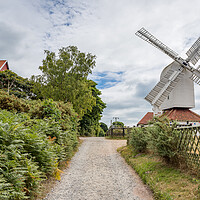 Buy canvas prints of Thorpeness windmill next to the House in the Clouds by Jason Wells