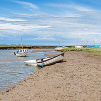 Buy canvas prints of Boats along a channel at Blakeney by Jason Wells