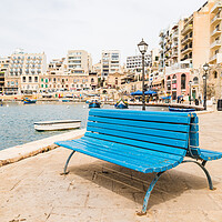 Buy canvas prints of Blue bench on the promenade at Spinola Bay by Jason Wells