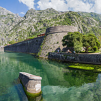 Buy canvas prints of Tourists sit next to the moat in Kotor by Jason Wells