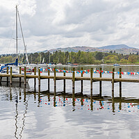 Buy canvas prints of Red and white bunting reflects in Lake Windermere by Jason Wells