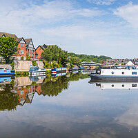 Buy canvas prints of Panorama of colourful narrow boats reflecting on t by Jason Wells