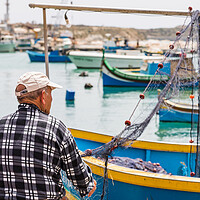 Buy canvas prints of Fisherman inspecting his fishing nets by Jason Wells