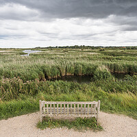Buy canvas prints of Lone bench overlooking the Titchwell nature reserve by Jason Wells