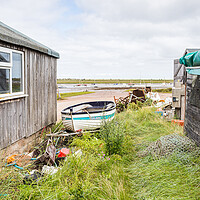 Buy canvas prints of Fishing boat between fishing huts at Brancaster Staithe by Jason Wells