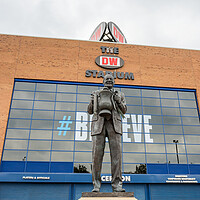 Buy canvas prints of Dave Whelan statue under the DW Stadium by Jason Wells
