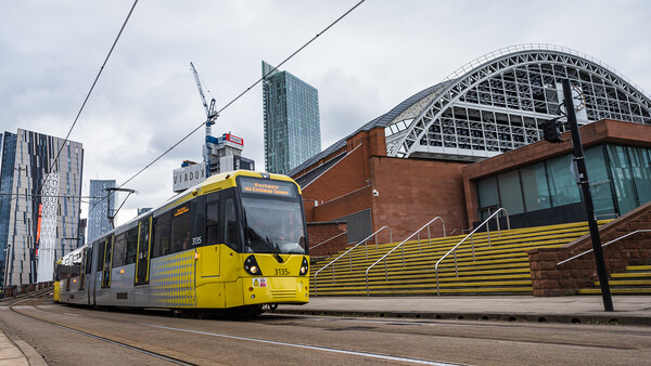 Yellow tram passing the Manchester Central Convention Complex Framed Print by Jason Wells