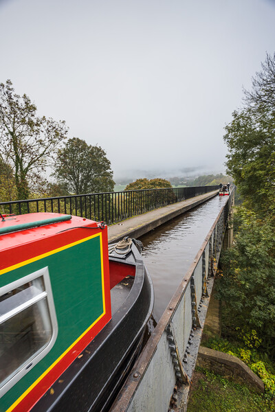 Narrow boat travels along the Pontcysyllte Aqueduct Picture Board by Jason Wells