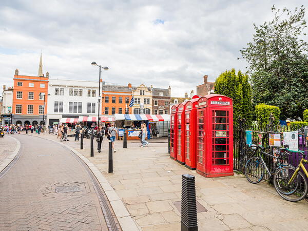 Red phone boxes next to Cambridge market Picture Board by Jason Wells