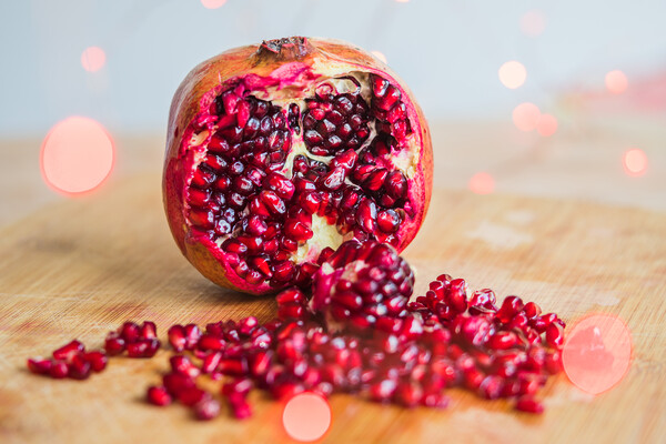Pomegranate seeds amongst red lights Picture Board by Jason Wells