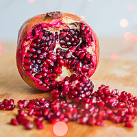 Buy canvas prints of Pomegranate seeds amongst red lights by Jason Wells