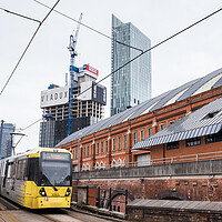 Buy canvas prints of Metrolink tram approaching Manchester city centre by Jason Wells