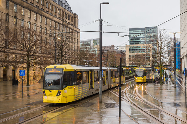 Trams passing in Manchester city centre Picture Board by Jason Wells