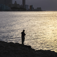 Buy canvas prints of Silhouette of a man fishing in Havana by Jason Wells
