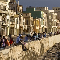 Buy canvas prints of Locals gather on the seawall of Havana by Jason Wells