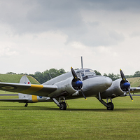 Buy canvas prints of Avro Anson parked on the grass by Jason Wells