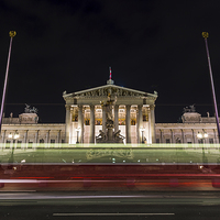 Buy canvas prints of Tram passing the Austrian Parliament Building at n by Jason Wells