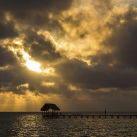 Buy canvas prints of Rays of sun above a jetty by Jason Wells