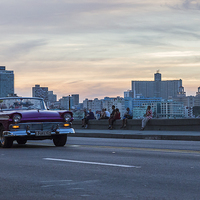 Buy canvas prints of Tourists in a vintage car on the Malecon by Jason Wells