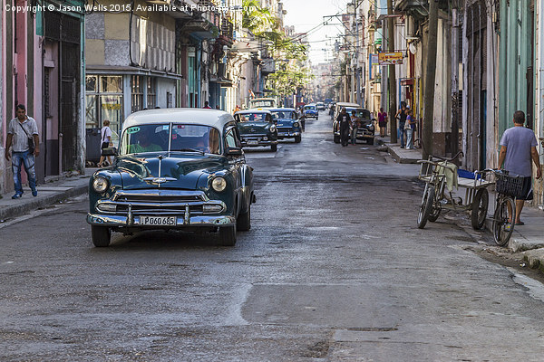 Facing a line of taxi's in Centro Havana Picture Board by Jason Wells