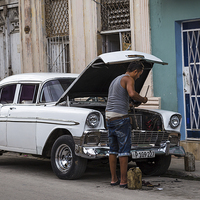 Buy canvas prints of Changing the oil in Centro Havana by Jason Wells