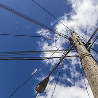 Buy canvas prints of Looking up at a chaotic telegraph pole by Jason Wells