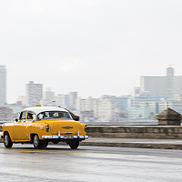 Buy canvas prints of Yellow taxi hurtling down the Malecon by Jason Wells