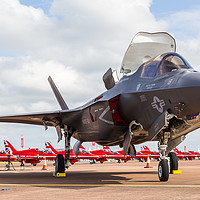 Buy canvas prints of F-35 Lightning II in front of the Red Arrows by Jason Wells